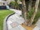 Kandla grey sandstone paving slabs with golden gravel and palm tree